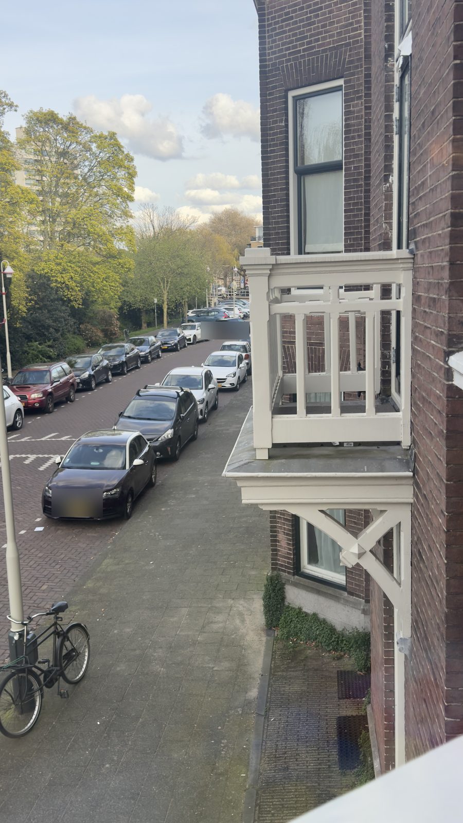 De rij geparkeerde auto's langs de smalle rijbaan van de Suezkade